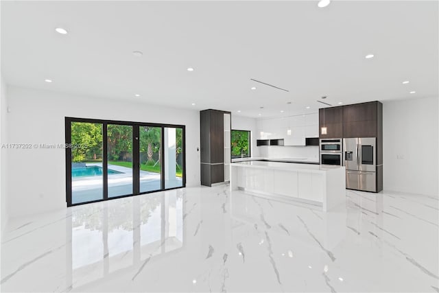 kitchen with dark brown cabinetry, stainless steel appliances, and a center island