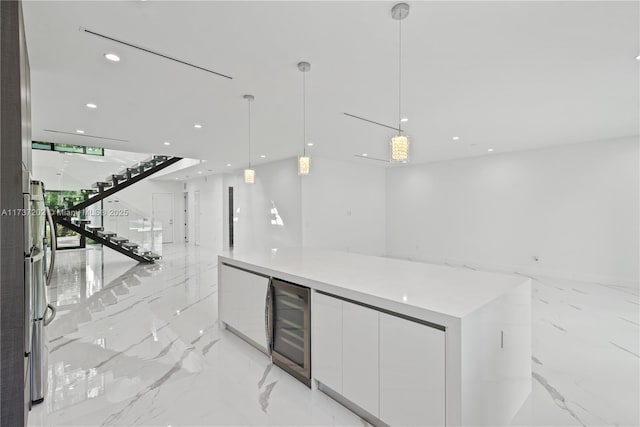 bar with white cabinetry, stainless steel fridge, beverage cooler, and decorative light fixtures