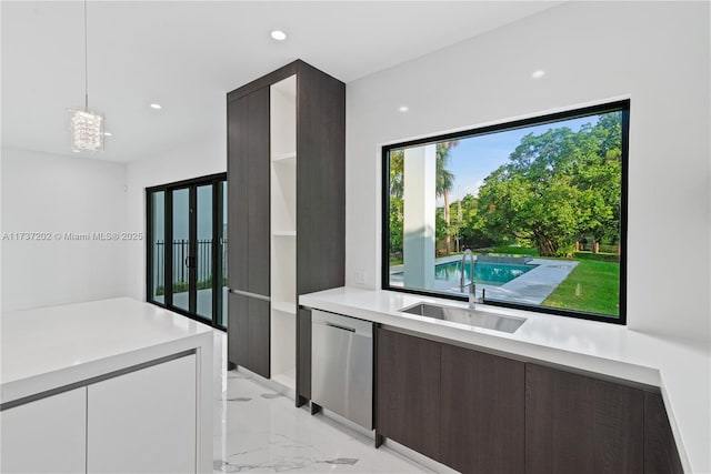 kitchen featuring sink, dishwasher, white cabinetry, dark brown cabinets, and decorative light fixtures