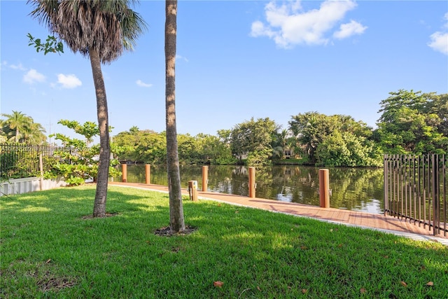 view of yard featuring a dock and a water view