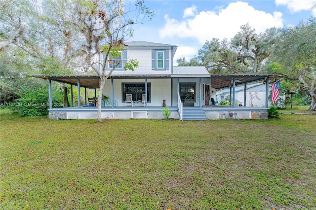 rear view of house featuring a yard