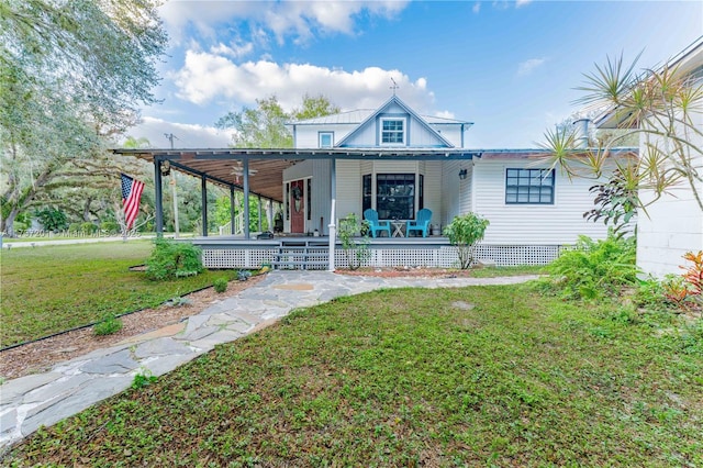 rear view of house with a porch and a lawn