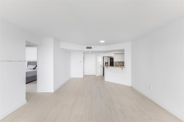 unfurnished room with light hardwood / wood-style flooring