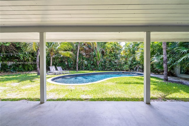 view of pool featuring a patio area and a lawn