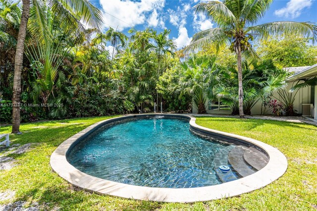 view of pool featuring a yard