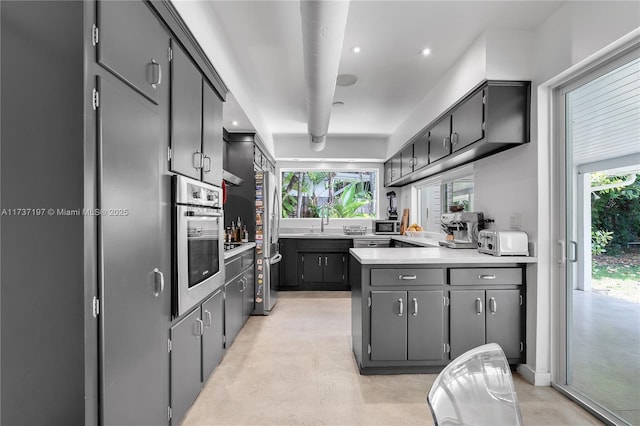 kitchen featuring appliances with stainless steel finishes, gray cabinets, and sink