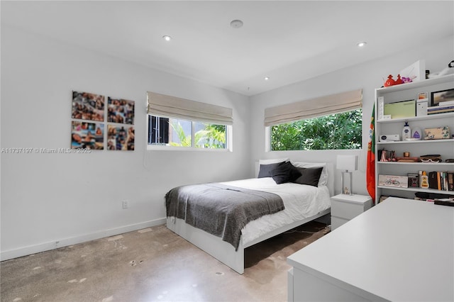 bedroom featuring concrete flooring