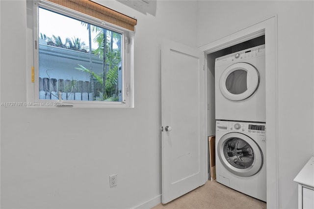 washroom featuring stacked washer / drying machine