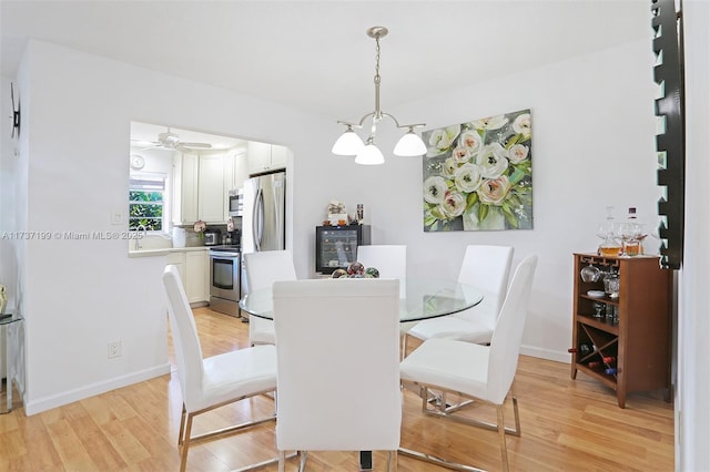 dining room featuring light hardwood / wood-style flooring and a chandelier