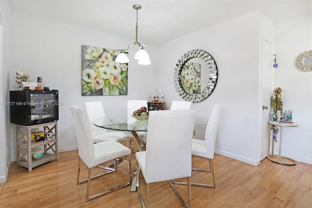 dining space with wood-type flooring