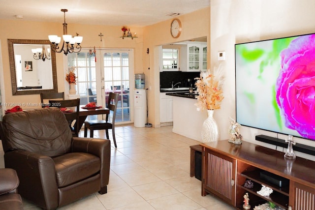 living room with an inviting chandelier and light tile patterned floors