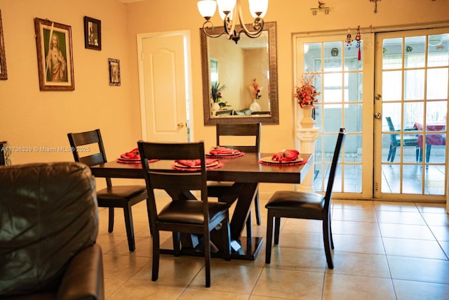 dining area featuring french doors, a chandelier, and light tile patterned floors