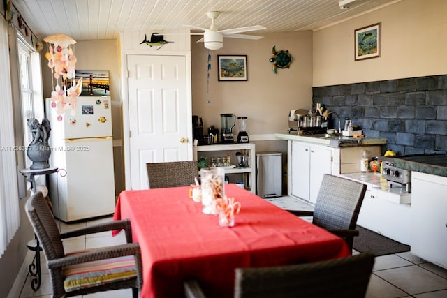 tiled dining space with wood ceiling and ceiling fan