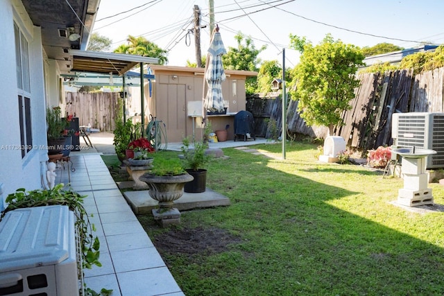 view of yard with a shed and cooling unit