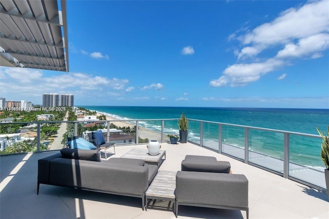 balcony with a water view and a beach view