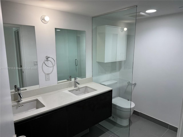 bathroom featuring vanity, toilet, and tile patterned flooring