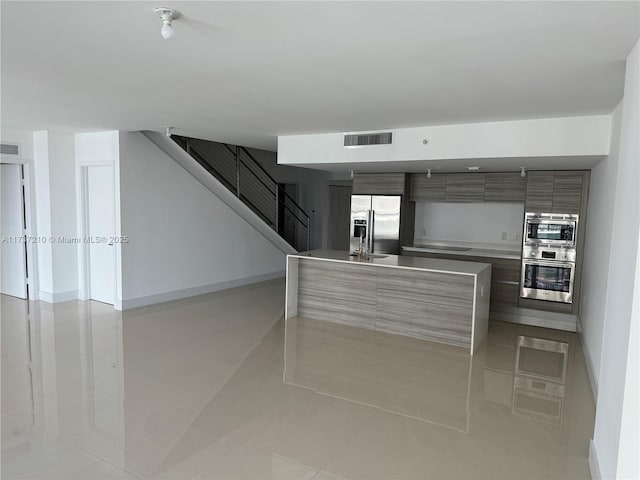 kitchen featuring appliances with stainless steel finishes and light tile patterned floors