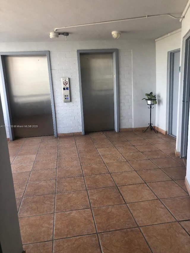 interior space featuring elevator and tile patterned floors