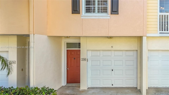 view of exterior entry featuring a garage