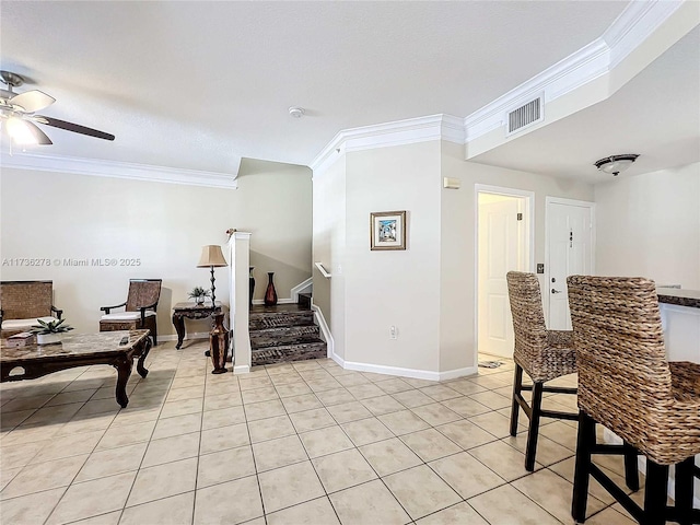 interior space featuring crown molding, ceiling fan, and light tile patterned flooring