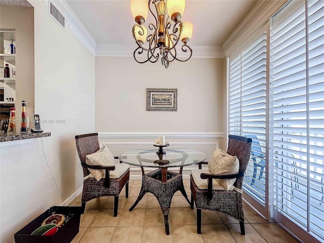 living area featuring crown molding, light tile patterned floors, and a chandelier