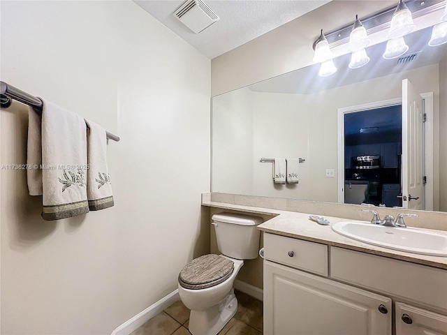 bathroom featuring tile patterned floors, toilet, and vanity