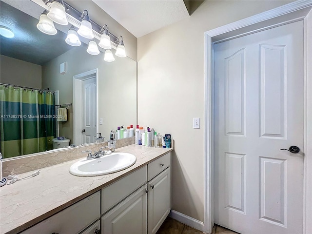 bathroom featuring vanity, curtained shower, tile patterned floors, and toilet