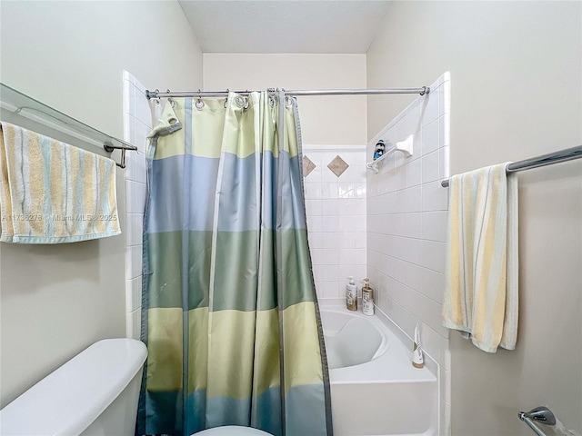 bathroom featuring shower / bath combo and toilet