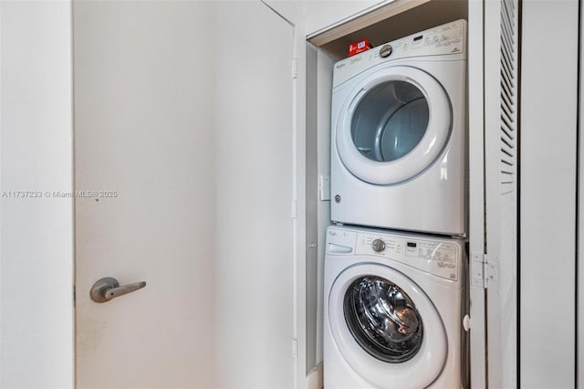 laundry room with stacked washer / dryer