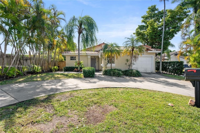 view of front of house featuring a garage and a front lawn