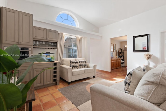 tiled living room with high vaulted ceiling