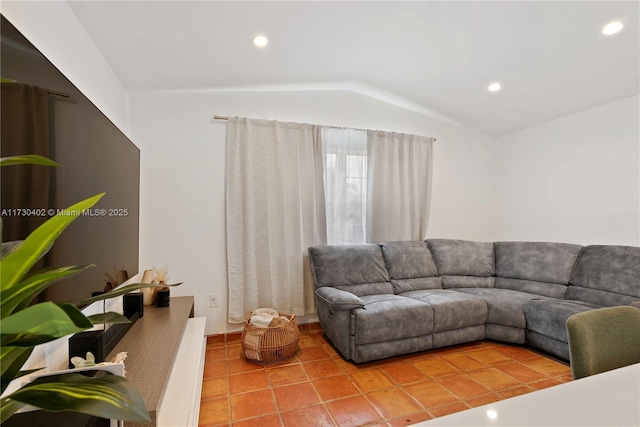 tiled living room featuring vaulted ceiling