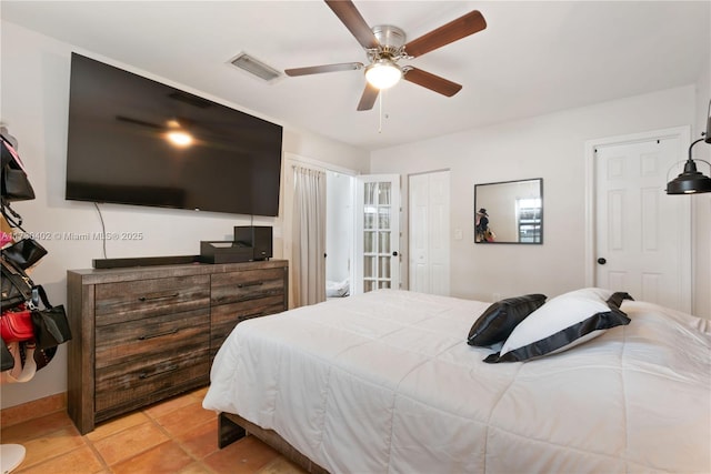 bedroom with light tile patterned floors and ceiling fan