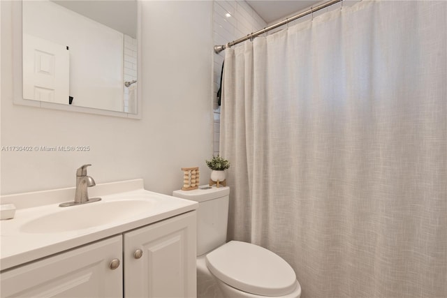 bathroom with vanity, walk in shower, and toilet