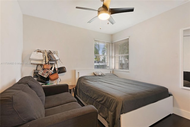 bedroom featuring dark hardwood / wood-style flooring and ceiling fan