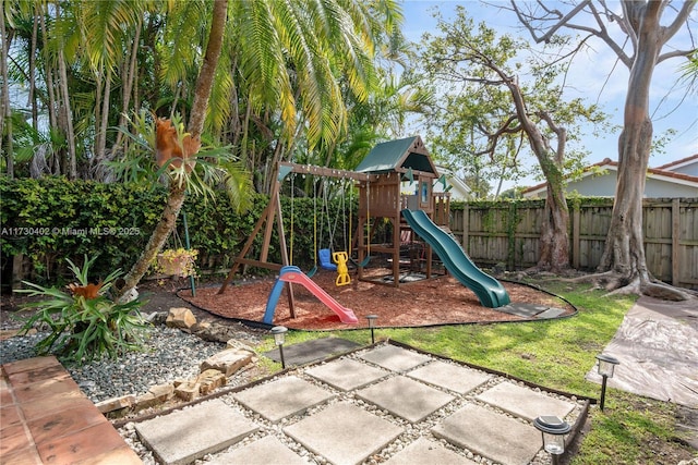 view of playground featuring a patio area