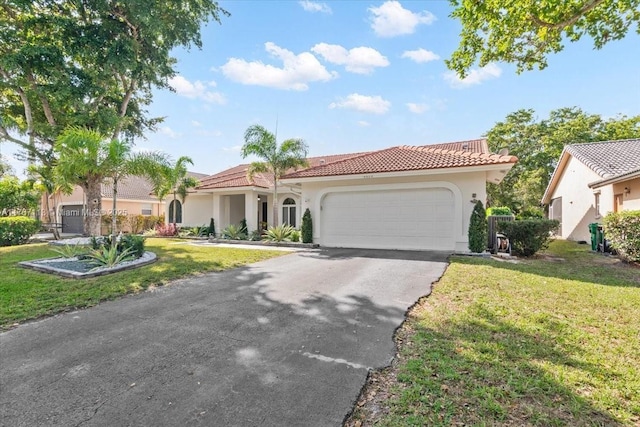 mediterranean / spanish home featuring a garage and a front yard