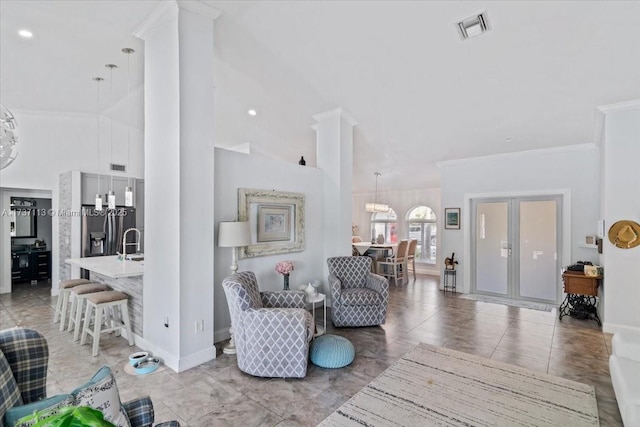 living room featuring high vaulted ceiling, ornamental molding, and sink