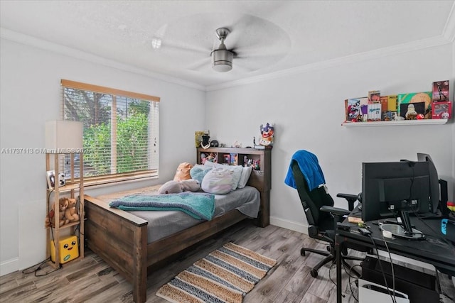 bedroom with hardwood / wood-style floors, crown molding, and ceiling fan