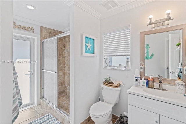 bathroom featuring tile patterned flooring, ornamental molding, vanity, toilet, and a shower with door