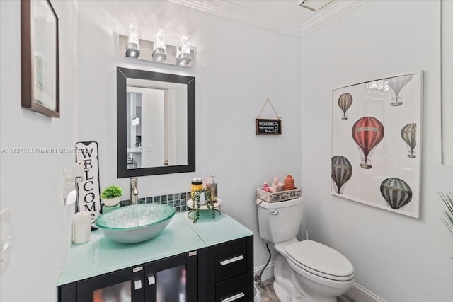 bathroom featuring crown molding, vanity, and toilet