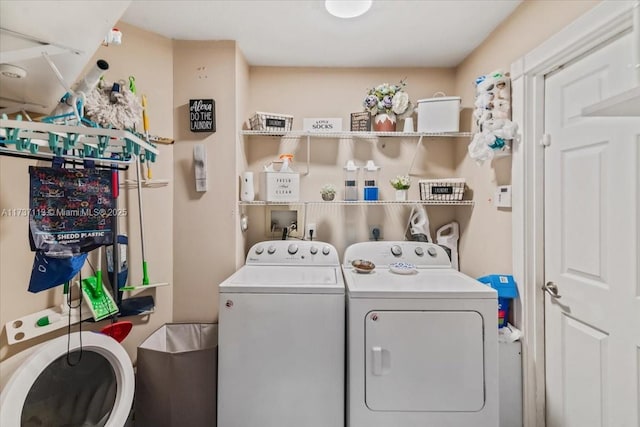 clothes washing area with washer and dryer