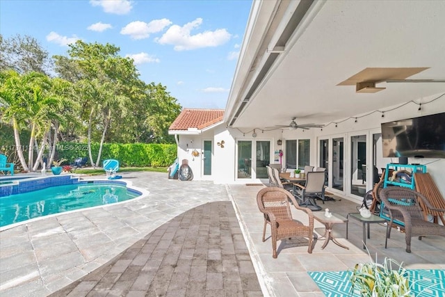 view of swimming pool with a patio area and ceiling fan