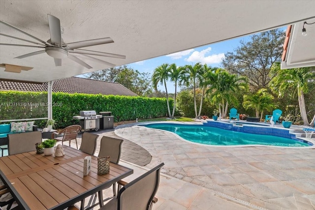 view of pool featuring a grill, a patio area, ceiling fan, and an in ground hot tub