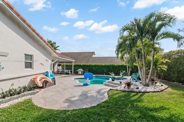 view of swimming pool featuring a yard and a patio area