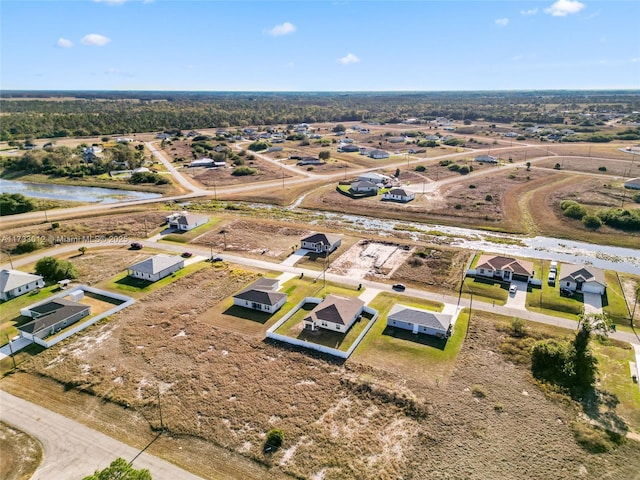 drone / aerial view featuring a residential view and a water view