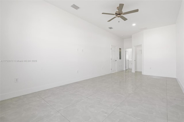 unfurnished room featuring ceiling fan, visible vents, and baseboards