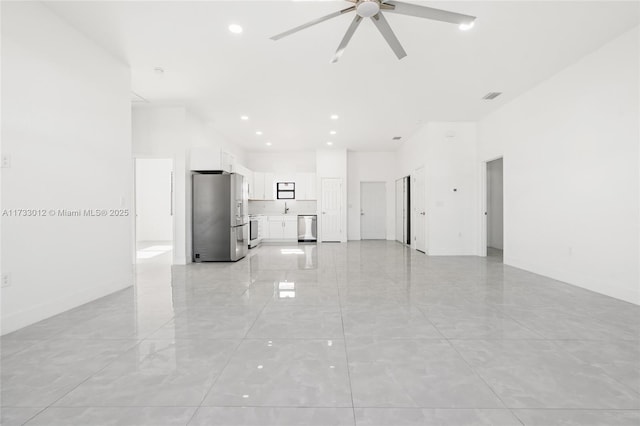 unfurnished living room with recessed lighting, a towering ceiling, visible vents, and a ceiling fan