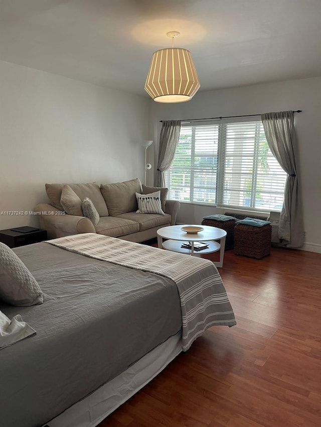 bedroom with dark hardwood / wood-style floors