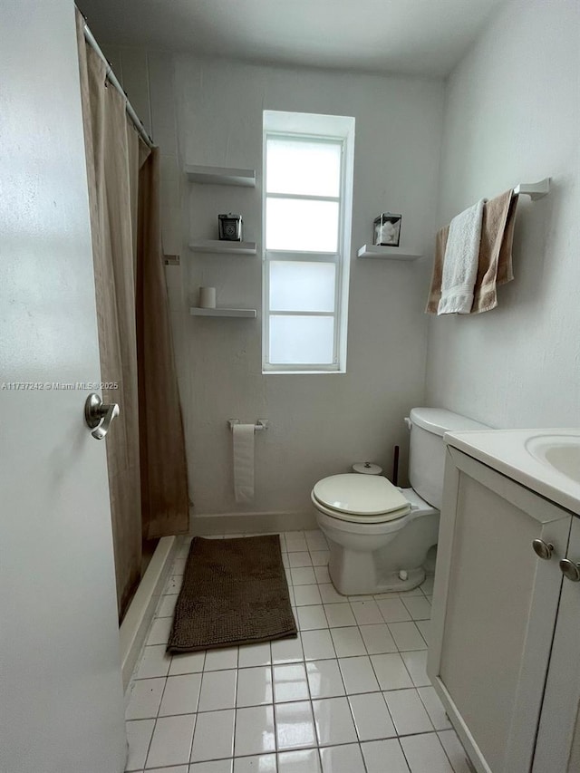 bathroom with vanity, curtained shower, tile patterned floors, and toilet